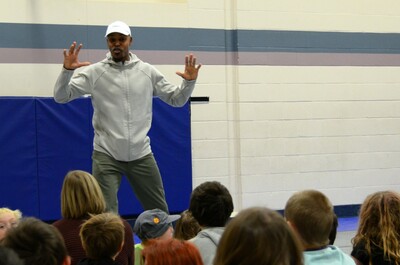 Matt Bucknor appears engaged and animated as he stands in front of a group of students.