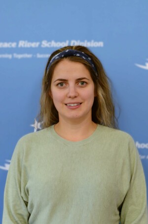 Photo of Edith, a woman, brown-blonde hair pulled back, wearing red headband, smiling and happy.